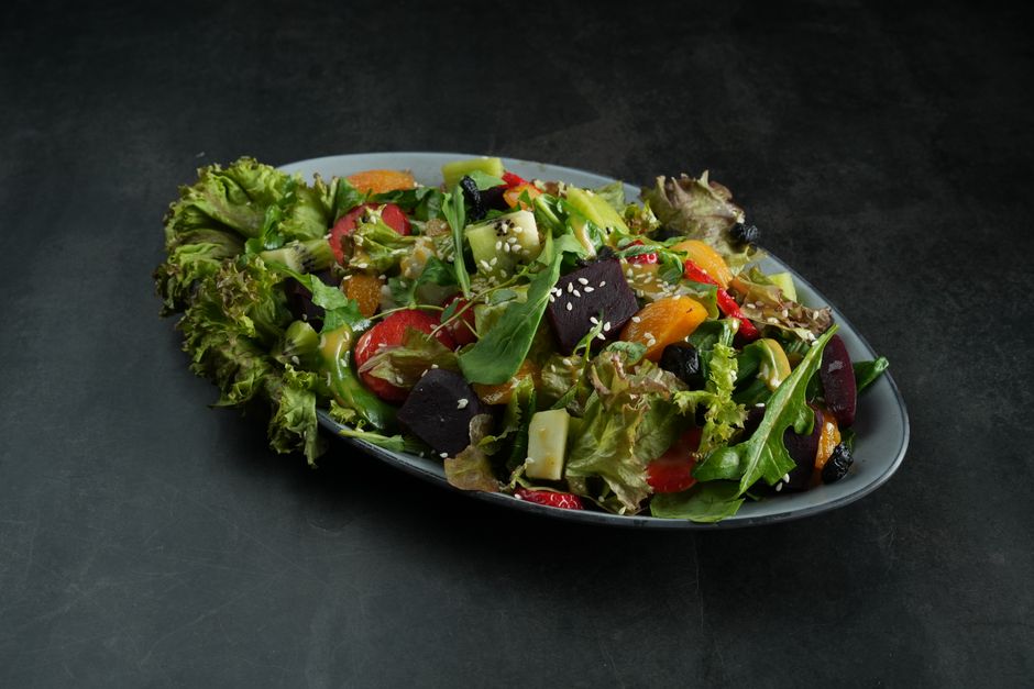 Colorful mixed salad with fresh vegetables and fruits on a gray background. - Photo by Dextar Studio ™ on Pexels